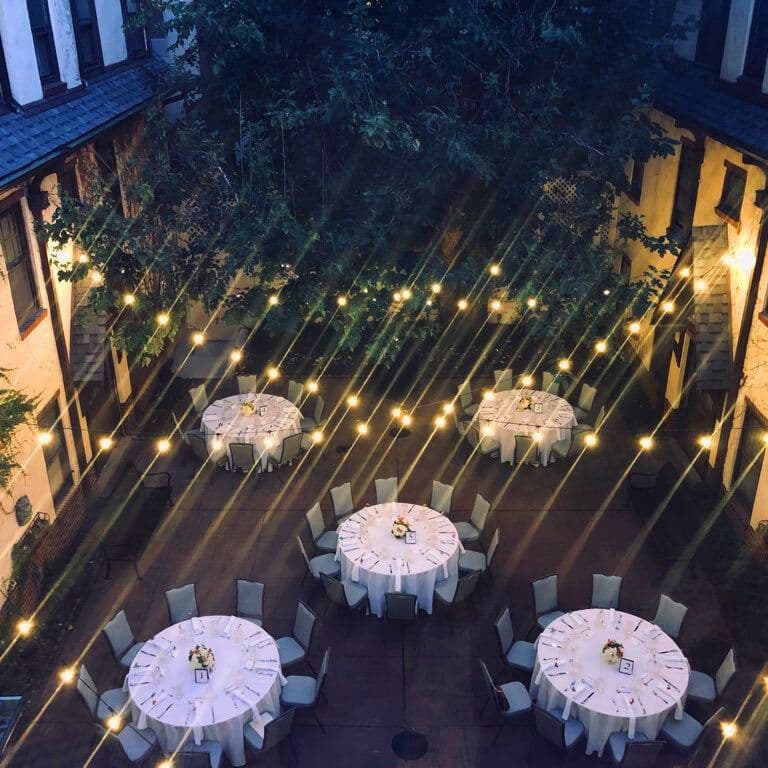 String lights over the courtyard in the evening