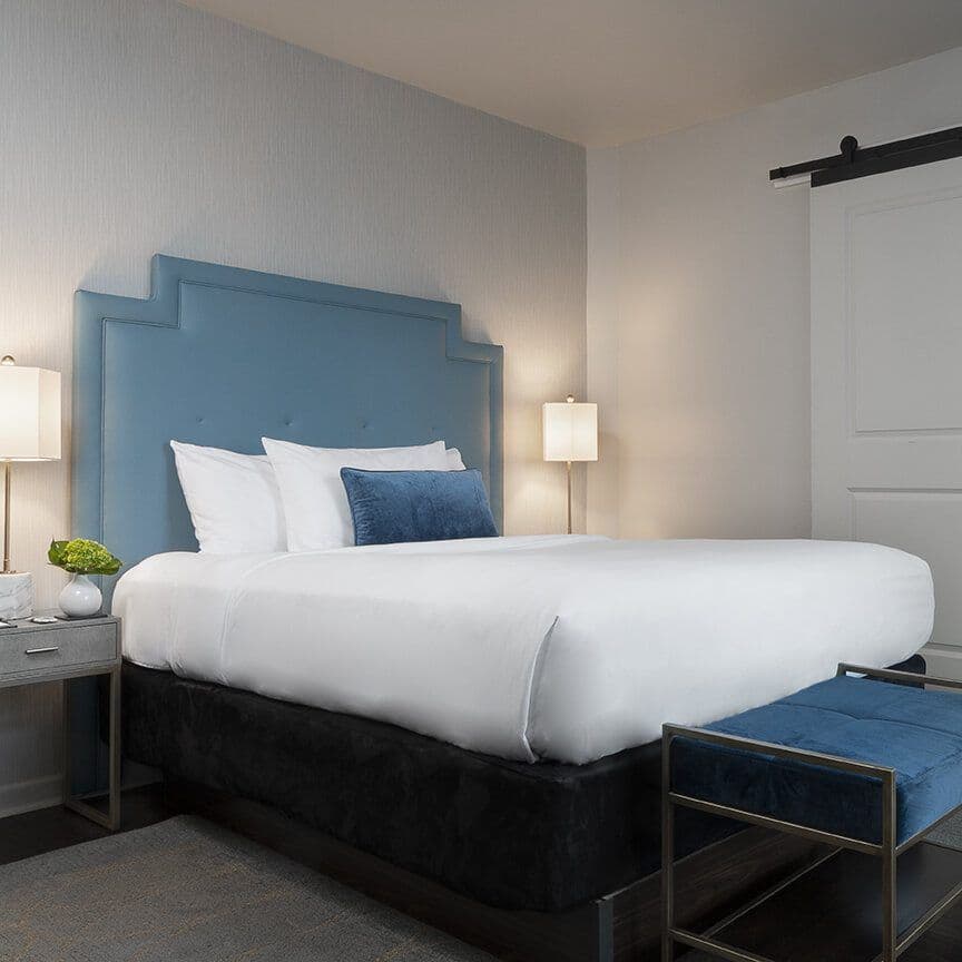 Single Queen room with a blue accent headboard